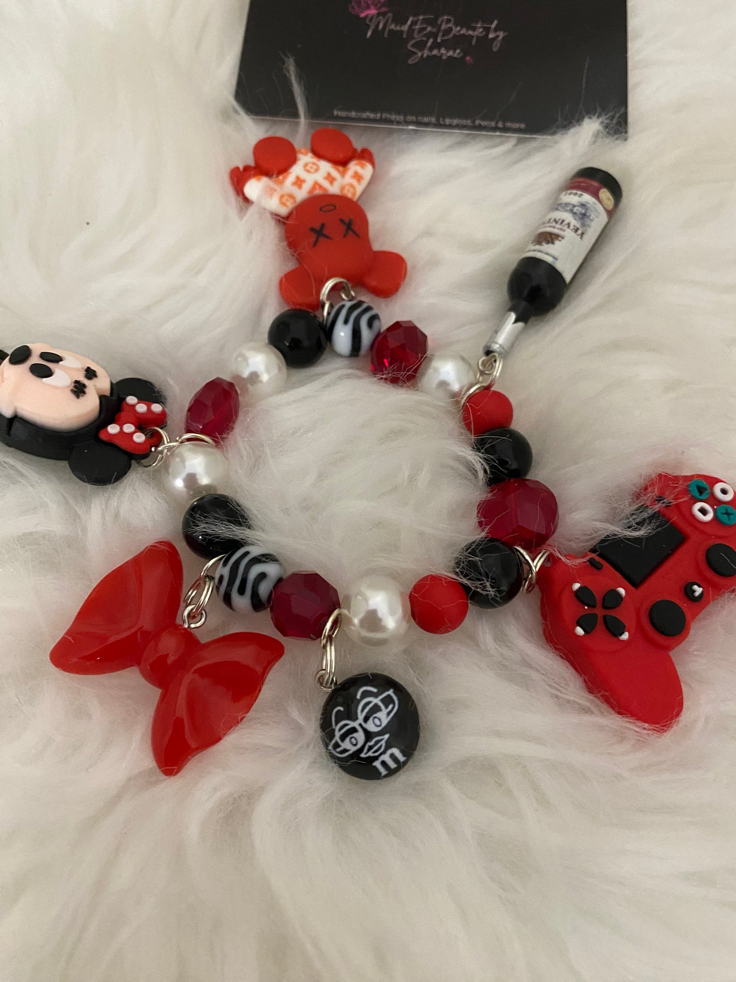 Red/black/white bracelet w charms