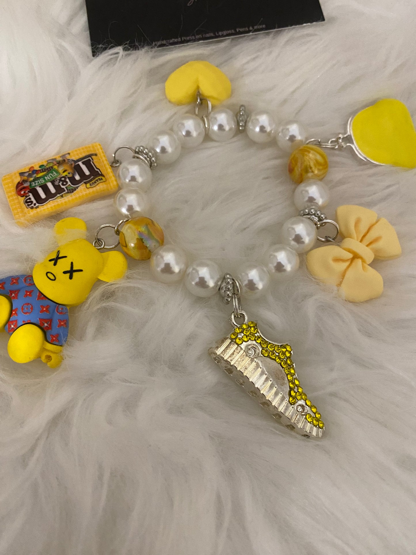 Yellow/white bracelet w charms