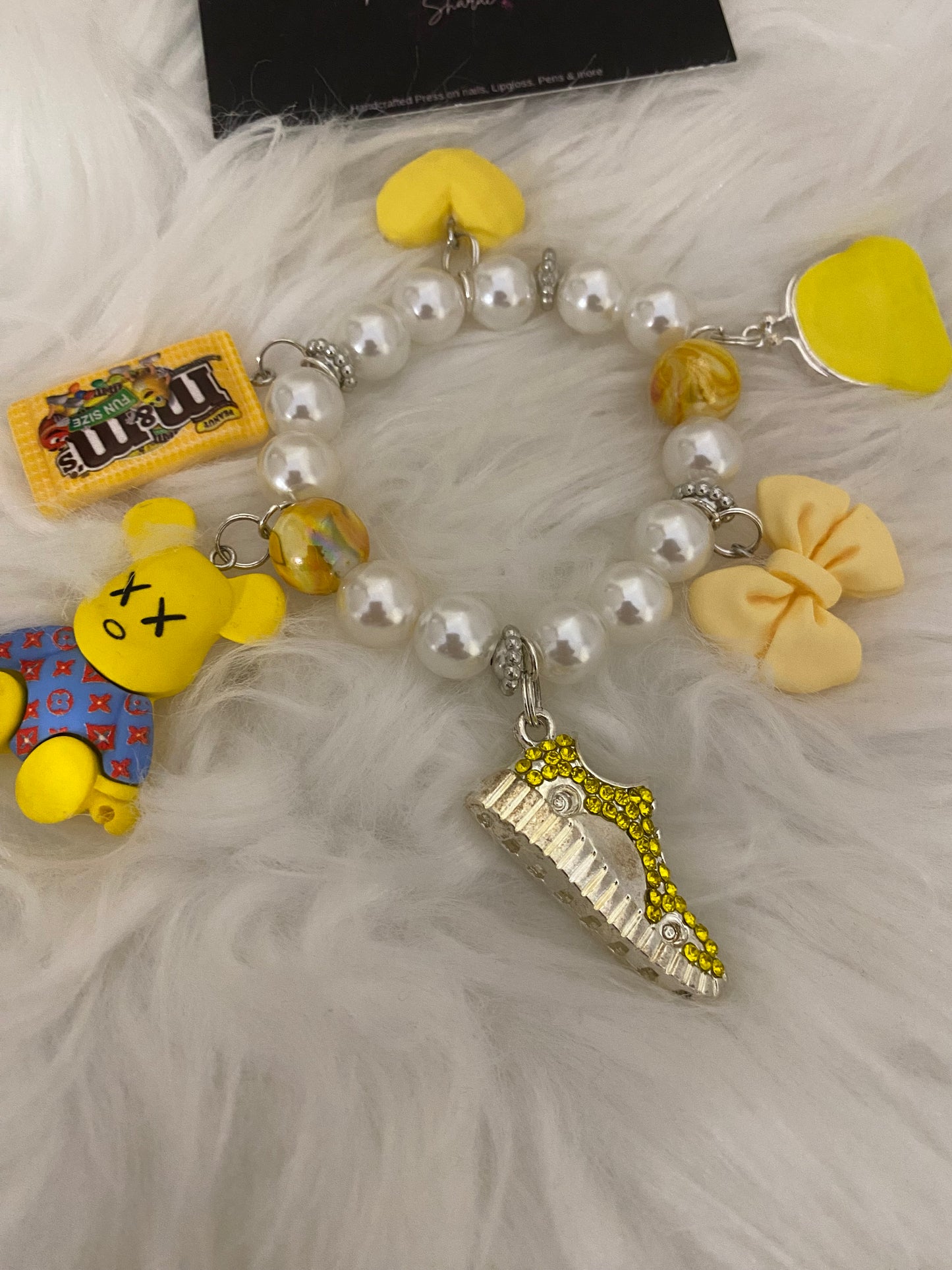 Yellow/white bracelet w charms